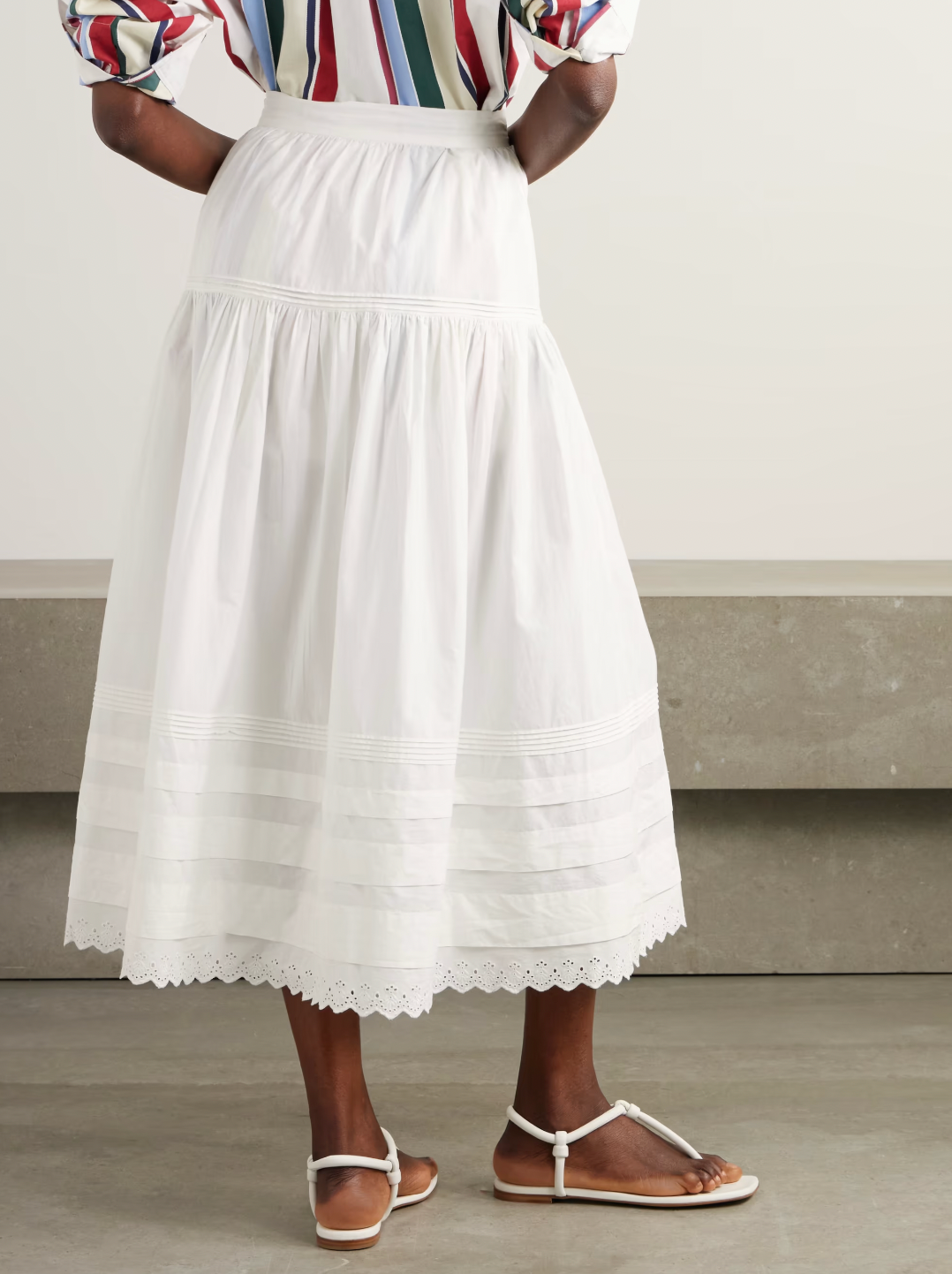Inspired by Edwardian bridal tradition, this Sebastiane skirt combines timeless elegance with modern sustainability. Crafted from organic cotton-poplin, its tiered silhouette features delicate pintucks and elegant broderie anglaise trim, adding a touch of vintage charm to your wardrobe. Perfect for those who appreciate refined detail and eco-conscious fashion.