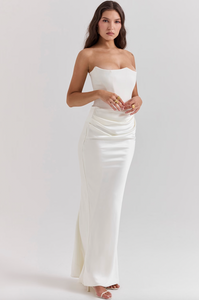 Indulge in luxury with the Ivory Strapless Corset Dress. Perfect for any high-octane occasion, this dress is crafted from stretch crepe and ultra luxe satin. The strapless neckline and boned bodice cinch the waist, while the beautifully draped skirt creates a striking silhouette. Make a statement with its flattering dress.