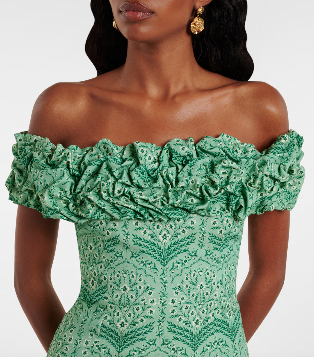 Discover the artistry of Agua by Agua Bendita's Jardín minidress, a stunning piece handcrafted by talented female artisans in Medellín, Colombia. This charming design features a soft cotton-blend poplin fabric with a playful ruffled hem and elegant off-shoulder neckline that flatters every silhouette. Each dress tells a story of skilled craftsmanship and celebrates the vibrant spirit of Colombian artistry. 