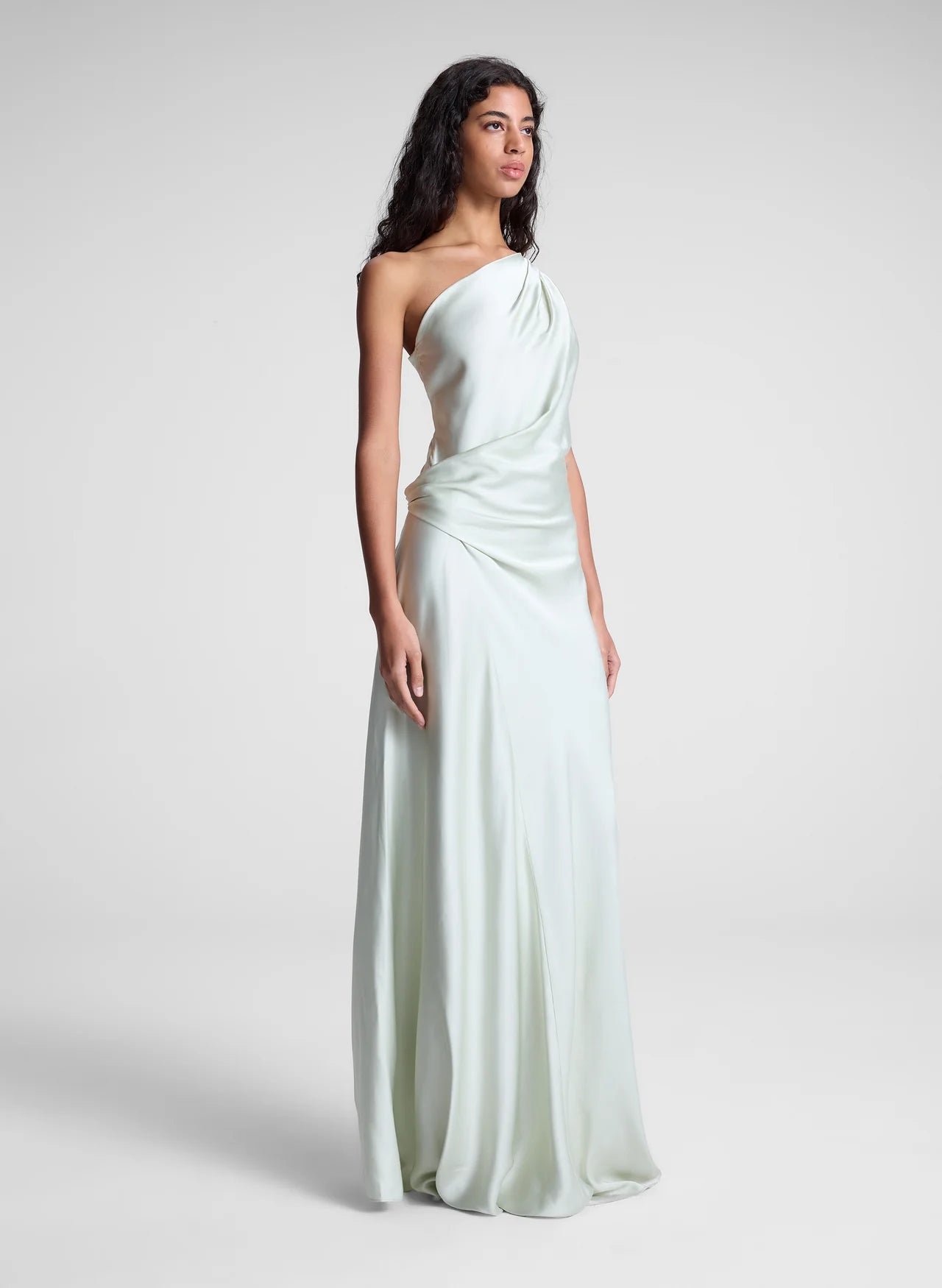 The Aster Satin One Shoulder Gown by A.L.C in radiant chartreuse offers a stunning blend of elegance and modern design. Crafted from smooth satin, it features a graceful one-shoulder cut that flows beautifully over the body. Soft pleats at the shoulder and waist sculpt the silhouette, while the asymmetrical design enhances movement and visual interest. Perfect for making a memorable statement, this gown effortlessly combines sophistication with bold charm.