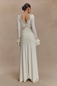 The Electra Maxi Dress combines elegant lace and a flattering fitted silhouette to create a captivating look. Its deep V lace neckline and delicate cut-outs add a touch of allure, while the cascading front-side tie drape enhances graceful movement. Flared layered sleeves bring a vintage charm, and the partial lining ensures comfort without compromising style. Perfect for making a memorable impression at any evening event, this dress shapes a sophisticated and sultry statement.