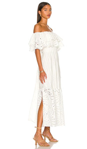 Get ready to show off your fun and flirty side with the Isabella Maxi Dress from Charo Ruiz! Made from a delicate broderie anglaise cotton-blend, this off-the-shoulder dress features tiered layers for added movement and style. Perfect for any occasion, this midi dress will have you feeling confident and fabulous.