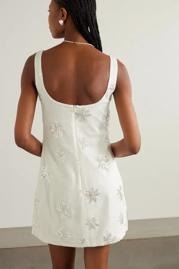 Embrace elegance with the Amelia Mini Dress. Crafted from lightweight gauze, this dress is delicately adorned with intricate beadwork, sequins, and faux pearls, forming beautiful leaf designs. Perfect for adding a touch of glamour to any occasion.