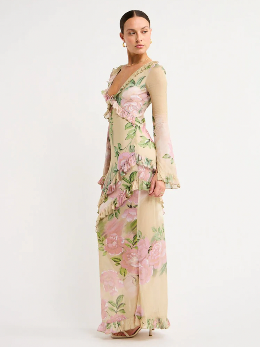 The Isabelle Quinn Louisa Dress in Romantic Floral is an elegant evening piece for special occasions.  Carefully crafted from a lightweight fabrication, this luxurious, full-length maxi dress features a ruffle neckline and a keyhole tie detailing,  Falling to skirt with femenine asymmetrical frill detailing, this unique silhouette is perfect for a birthday celebration, cocktail hour, or date night. 