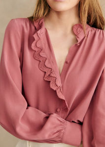 Experience elegance and sophistication with the Chloe Blouse! This long sleeve shirt features a high collar and stunning embroidered band on the placket and collar. The covered buttons add a touch of luxury to this must-have piece. Elevate your wardrobe with this timeless and stylish blouse.