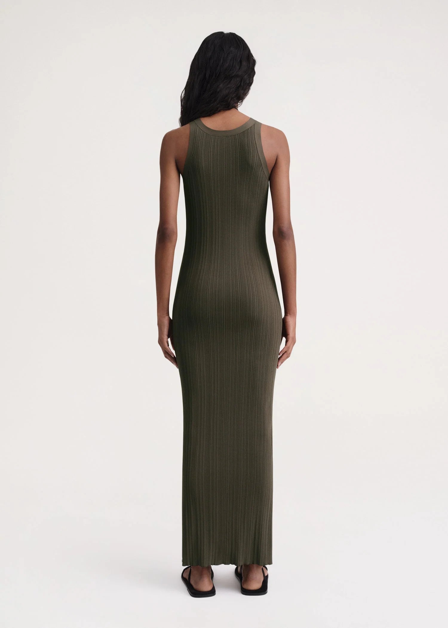 Elevate your style game with our TOTEME Khaki Seamless Midi Dress. Made from a luxurious rib knit blend of viscose and recycled nylon, this dress molds to your body for a flawless fit. Perfect for any occasion, this dress exudes sophistication and exclusivity.