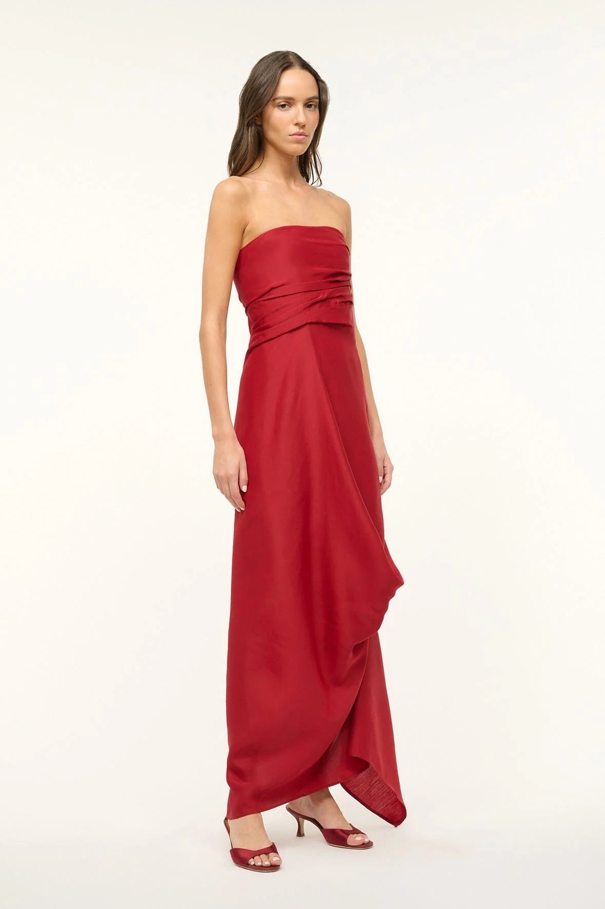 Unleash your daring side with the Caravaggio Dress Rouge by STAUD! This luxurious maxi dress, crafted from a silk wool blend, drapes elegantly and offers structural support with its built-in corset. Perfect for any adventure, this dress combines ease and sophistication. Embrace the challenge and stand out in style!