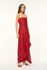 Load image into Gallery viewer, Unleash your daring side with the Caravaggio Dress Rouge by STAUD! This luxurious maxi dress, crafted from a silk wool blend, drapes elegantly and offers structural support with its built-in corset. Perfect for any adventure, this dress combines ease and sophistication. Embrace the challenge and stand out in style!
