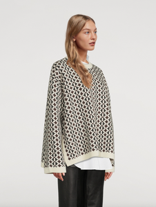 Indulge in the luxurious warmth and style of the Knit Cross-Pattern Wool Pullover by TOTEME. Crafted from high-quality virgin wool, this Norwegian-inspired piece boasts a structured fit and wide silhouette for a sophisticated look. The jacquard woven fabric features a unique cross pattern, while the ribbed neck, cuffs, and hem add texture and comfort. With dropped shoulders and side slits, this pullover is both elegant and versatile. 