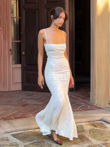 Introducing the Joan Dress: a stunning white maxi dress for women that exudes elegance and sexiness. Its slim fit and backless design accentuate your figure, while the thin straps add a touch of sophistication. Perfect for special occasions, this dress will make you feel confident and alluring.