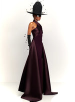 Load image into Gallery viewer, Experience red carpet glamour and drama with the Solace London Rumi Maxi Dress in Plum. This stunning gown is designed to turn heads, with its body-sculpting stretch-crepe fabric and voluminous floor-length hem. The satin-faille wrap detail at the neck and waist adds an extra touch of luxury to this show-stopping dress.
