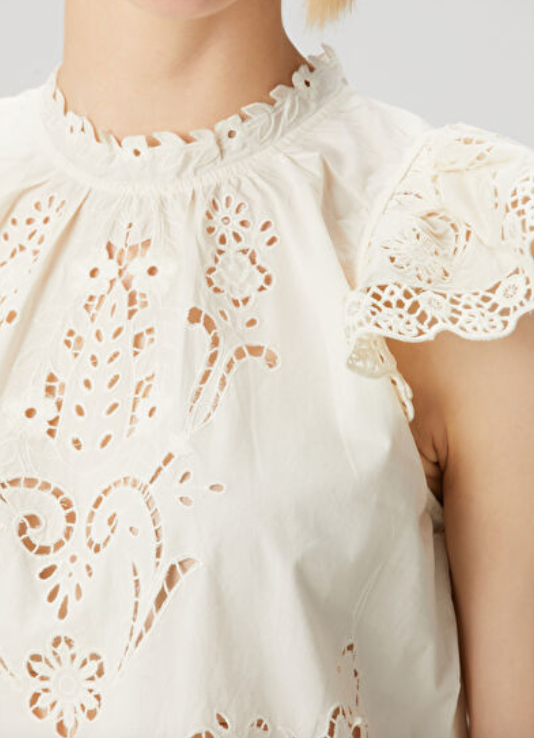Elevate your wardrobe with the Gianna Bone Lace Blouse by SEA, featuring a refined mandarin collar that adds subtle sophistication. Delicate lace and ruffle details enhance its tank top design, blending elegance with breathable comfort. Ideal for layering or wearing alone, this blouse offers a polished look perfect for both professional settings and stylish casual occasions.