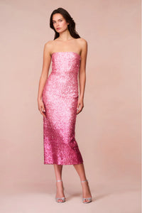 Introducing the Stasia Midi Dress, the star of your next party. Made from a luxurious sequin sheathing fabric, this dress features a stunning ombre pattern in shades of light pink to deep fuchsia. Shimmer and shine all night long with added glitter details. Elevate your event or holiday look with LoveShackFancy's signature sparkle.