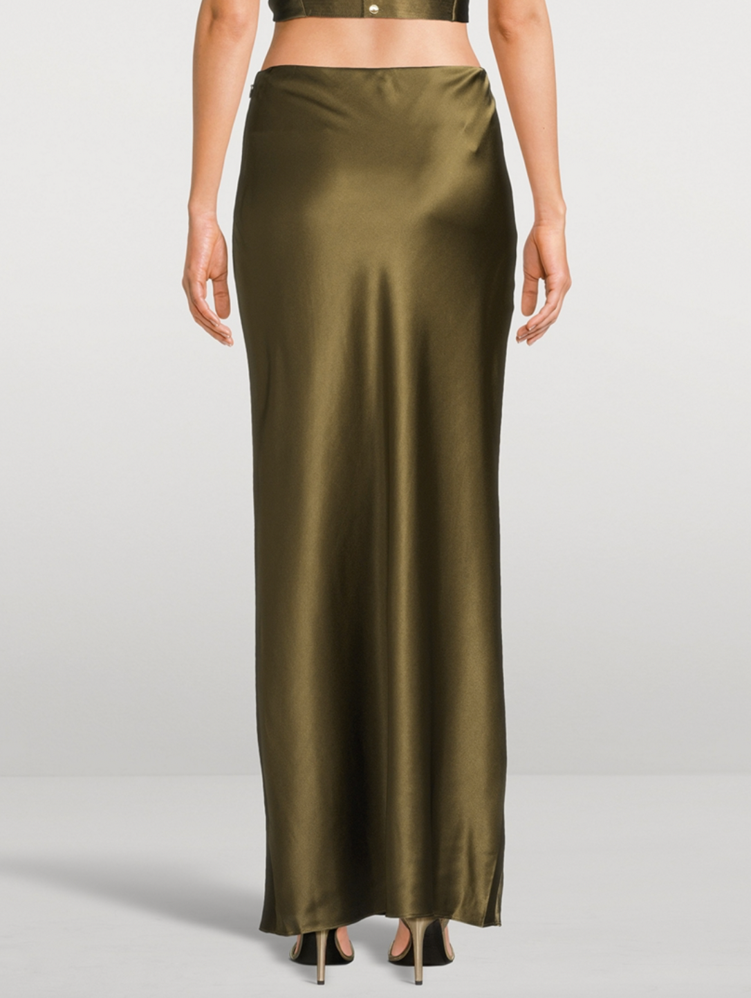Experience effortless elegance with the Chantel Satin Slip Skirt by Cult Gaia. Cut on the bias for a flattering fit, this maxi-length piece is crafted from glossy silk that gently stretches for comfort. Its smooth, flowing silhouette enhances every movement, making it perfect for both day and evening wear. Elevate your wardrobe with this timeless, luxurious skirt that exudes sophistication and versatility.