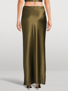 Experience effortless elegance with the Chantel Satin Slip Skirt by Cult Gaia. Cut on the bias for a flattering fit, this maxi-length piece is crafted from glossy silk that gently stretches for comfort. Its smooth, flowing silhouette enhances every movement, making it perfect for both day and evening wear. Elevate your wardrobe with this timeless, luxurious skirt that exudes sophistication and versatility.