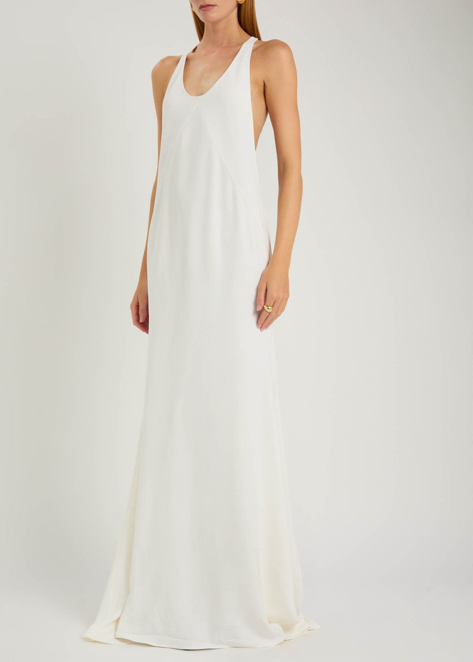 Experience modern sophistication with the Marcel crepe maxi dress by Jacquemus. Its sleek racerback silhouette and expertly crafted panels gently contour your figure, while the smooth crepe fabric flows gracefully to the floor. Perfect for minimalist sandals and delicate jewelry, this dress combines sporty elegance with subtle glamour, making it an effortless choice for refined, polished looks.