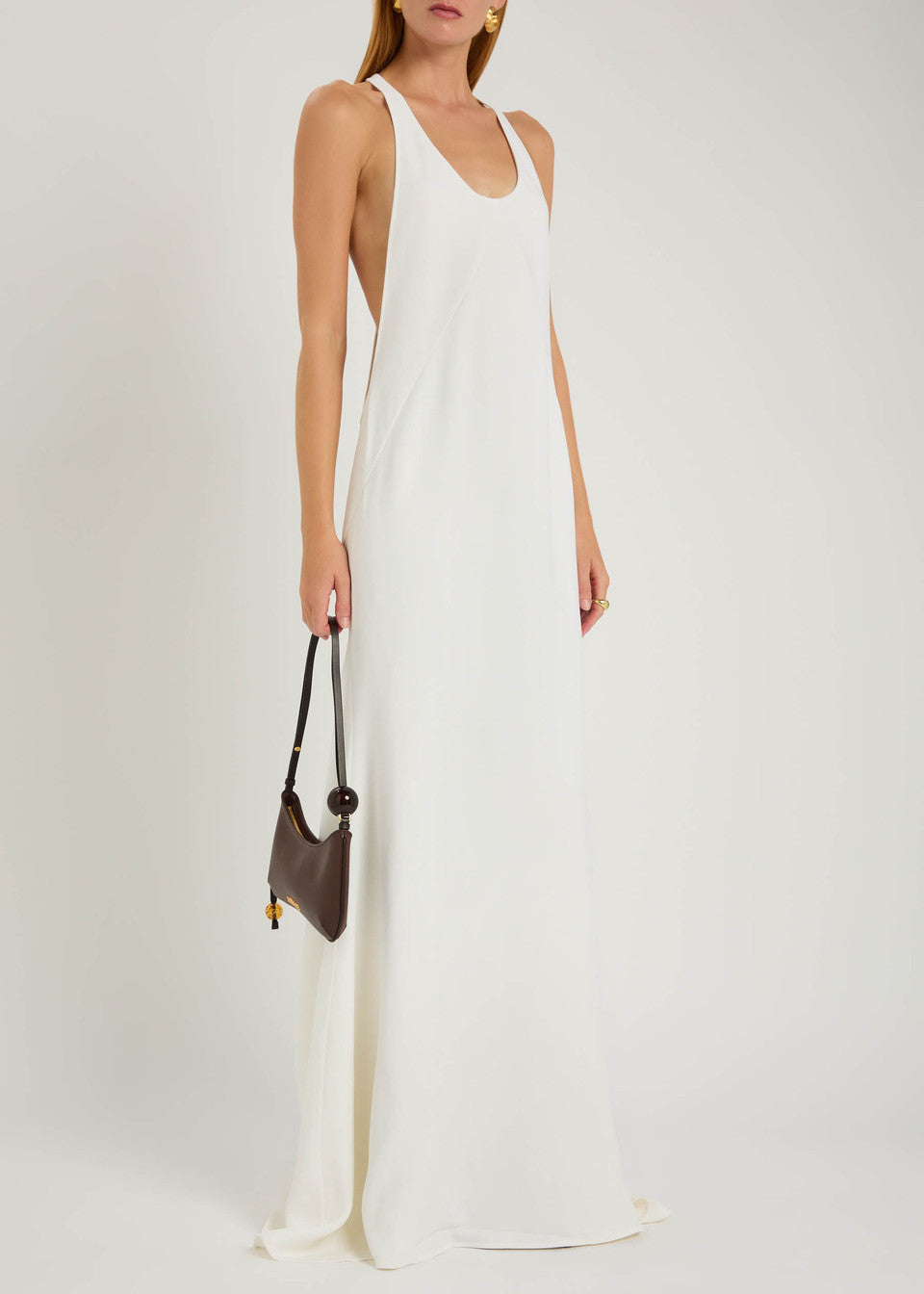 Experience modern sophistication with the Marcel crepe maxi dress by Jacquemus. Its sleek racerback silhouette and expertly crafted panels gently contour your figure, while the smooth crepe fabric flows gracefully to the floor. Perfect for minimalist sandals and delicate jewelry, this dress combines sporty elegance with subtle glamour, making it an effortless choice for refined, polished looks.