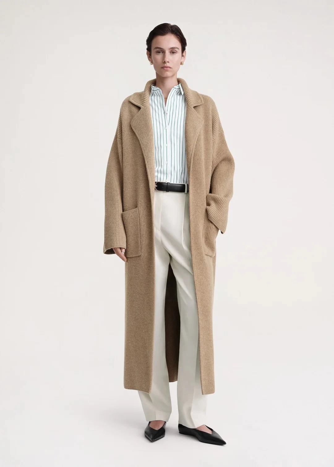 Introducing the Totême Rib Knit Coat, a luxurious and elegant addition to any wardrobe. Keep warm in style with this sophisticated tan coat, boasting a rib knit design for added texture. Elevate your look and feel exclusive in this timeless piece.