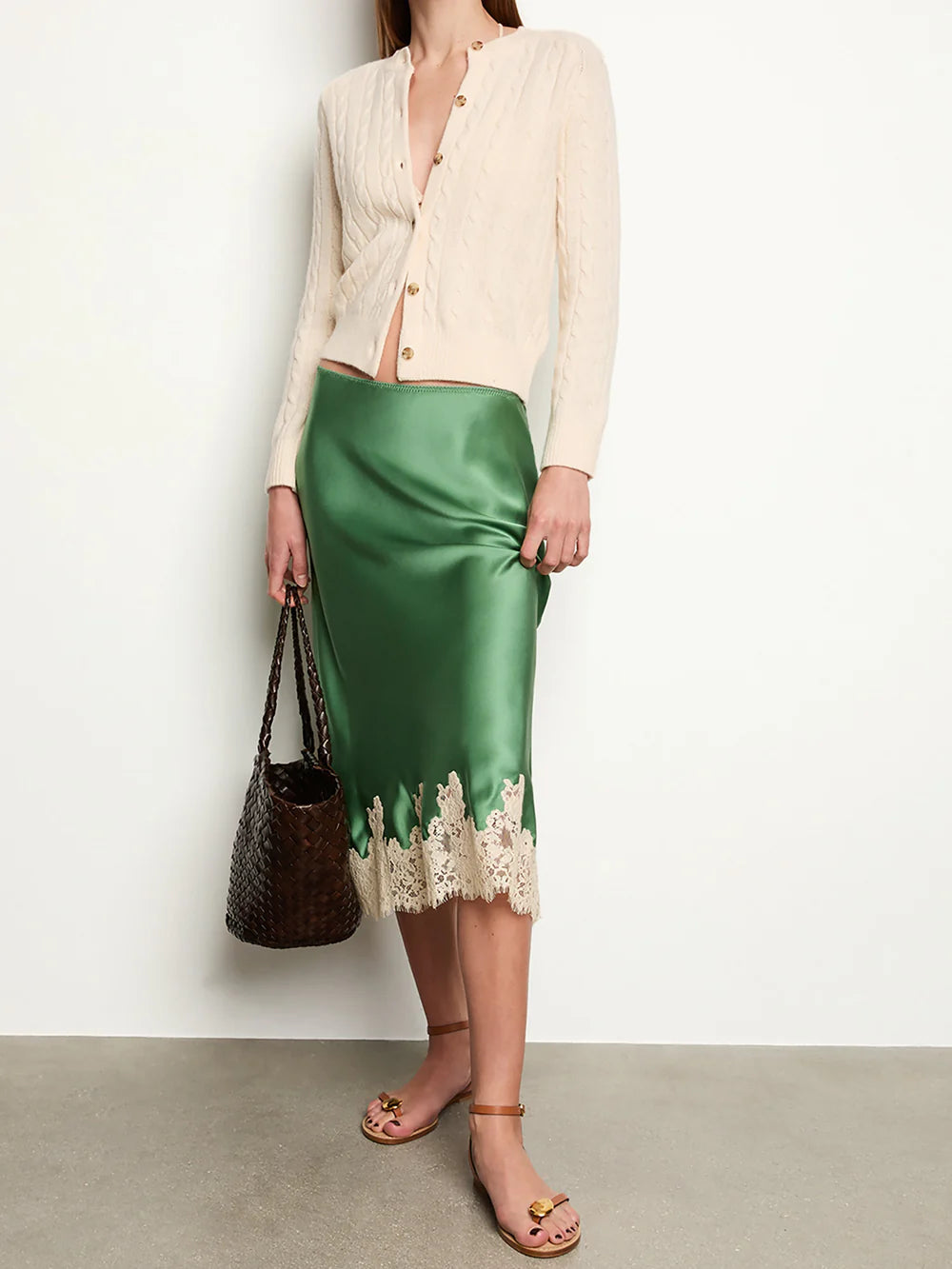 The Elowena Skirt features a scallop-edged elastic waistband for effortless slip-on wear. Crafted from buttery silk and cut on the bias, it drapes fluidly for a graceful silhouette. Its delicate ivory floral-lace hem adds a refined, feminine touch, making this skirt both elegant and comfortable for versatile styling.