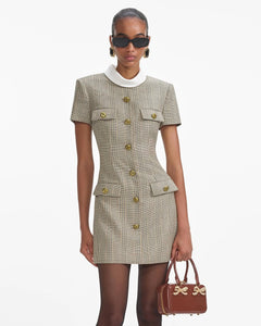 Experience the ultimate in luxury with the Check Wool Mini Dress by Self-Portrait. Fully lined and featuring a faux front button closure, this dress offers both convenience and sophistication. The midweight twill fabric is complemented by padded shoulders, creating a chic and bold silhouette. Plus, the 4-pocket design adds functionality to this stylish piece.