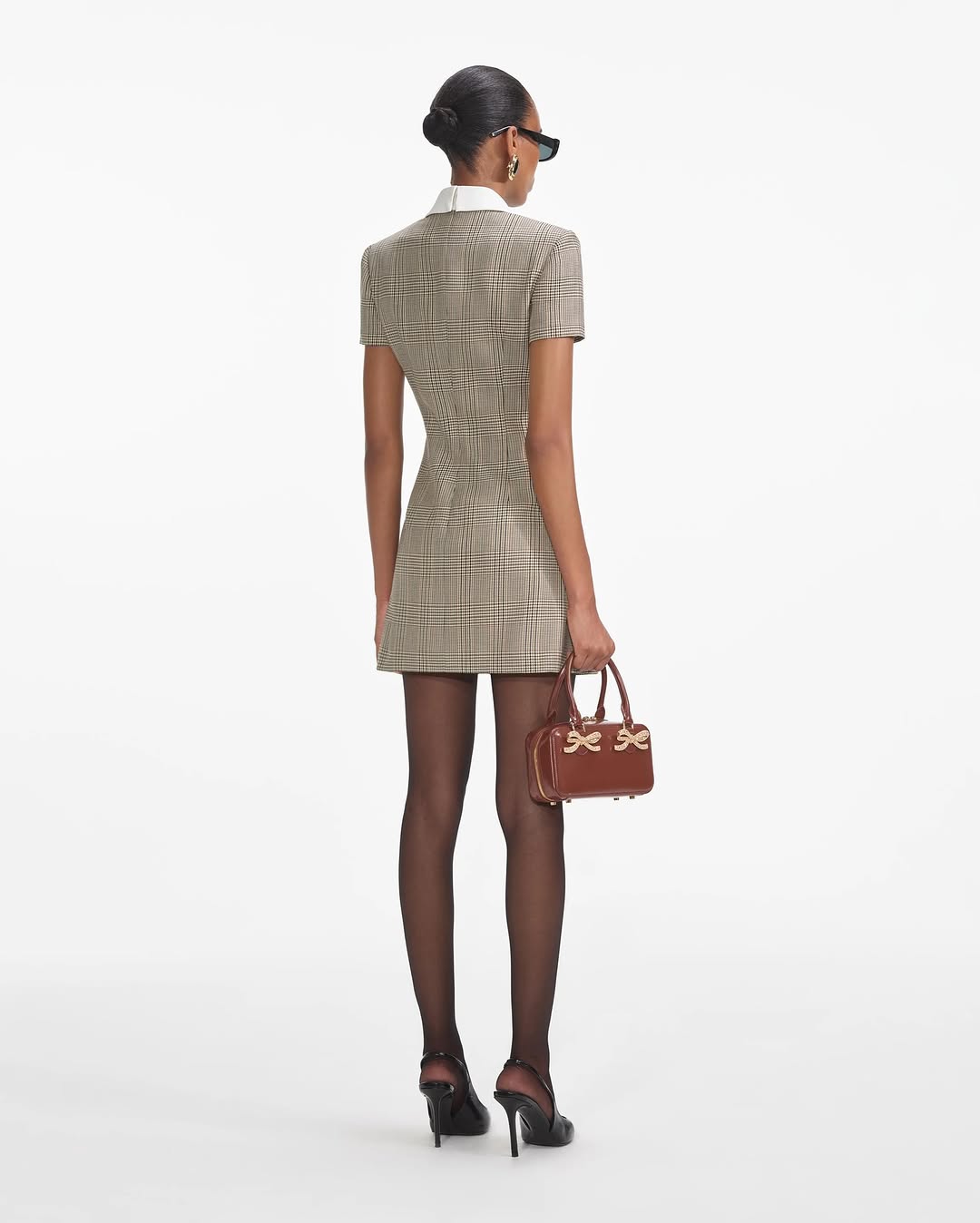 Experience the ultimate in luxury with the Check Wool Mini Dress by Self-Portrait. Fully lined and featuring a faux front button closure, this dress offers both convenience and sophistication. The midweight twill fabric is complemented by padded shoulders, creating a chic and bold silhouette. Plus, the 4-pocket design adds functionality to this stylish piece.