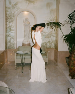 The Constantina Jersey Dress With Bow blends sophisticated design with comfort. Crafted from soft jersey fabric, it offers a flattering pull-on fit highlighted by distinctive cut-outs at the back and waist, creating a contemporary silhouette. Its partial lining ensures ease of wear, while the delicate satin bow adds an elegant finishing touch. Perfect for special occasions, this dress is a refined choice that seamlessly marries style and comfort.