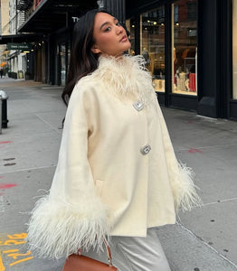 Experience unparalleled elegance and warmth with the Angelica Coat. Made from sumptuous ostrich wool, its flattering A-line shape ensures comfort and style during colder days. Eye-catching fur details on the sleeves and neckline add a luxurious edge, while custom silver buckles offer a refined, exclusive touch. This coat is the perfect choice for those who want to stay chic and cozy all winter long.