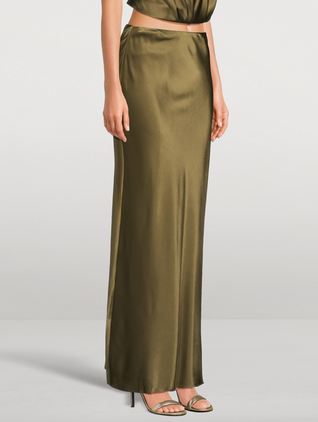 Experience effortless elegance with the Chantel Satin Slip Skirt by Cult Gaia. Cut on the bias for a flattering fit, this maxi-length piece is crafted from glossy silk that gently stretches for comfort. Its smooth, flowing silhouette enhances every movement, making it perfect for both day and evening wear. Elevate your wardrobe with this timeless, luxurious skirt that exudes sophistication and versatility.