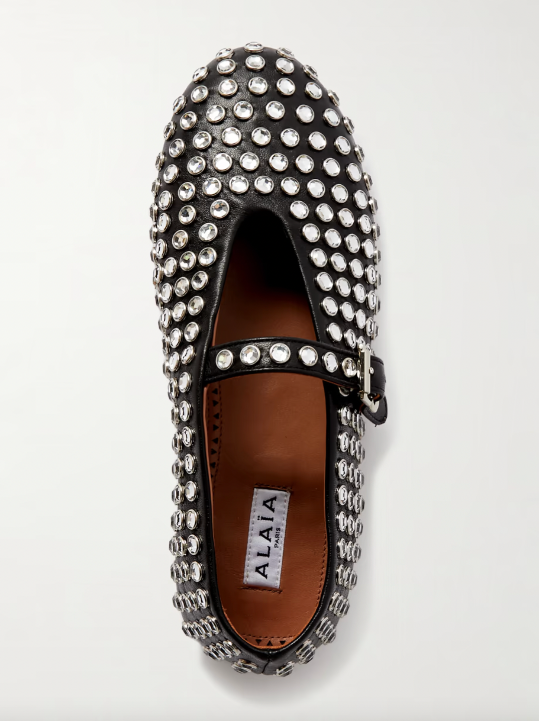 Transform any outfit into a showstopper with ALAÏA's crystal-embellished leather ballet flats. These luxurious and elegant flats add a touch of glamour to any occasion. Comfortable yet stylish, these flats are perfect for any fashion-forward individual. Elevate your wardrobe with these stunning ballet flats!