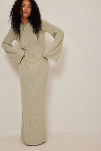 Get ready to turn heads with our Merryl Knitted Dress! This stunning maxi dress features a unique knitted design that will keep you comfortable and stylish all day long. The deep back, tied at the neck, and wide sleeves add a touch of elegance to this dress. Available in beige, it's the perfect addition to your wardrobe for any occasion.