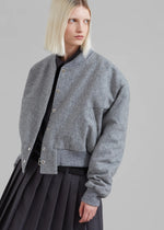 Load image into Gallery viewer, Introducing the Debbie Wool Bomber Jacket by The Frankie Shop, crafted from luxurious midweight woven wool. With a relaxed fit and cropped profile, it exudes an elegant and exclusive style. The ribbed baseball collar, front welted pockets, and elasticated ribbed trim add both sophistication and functionality. Snap up the front button closure for a timeless and tailored look.
