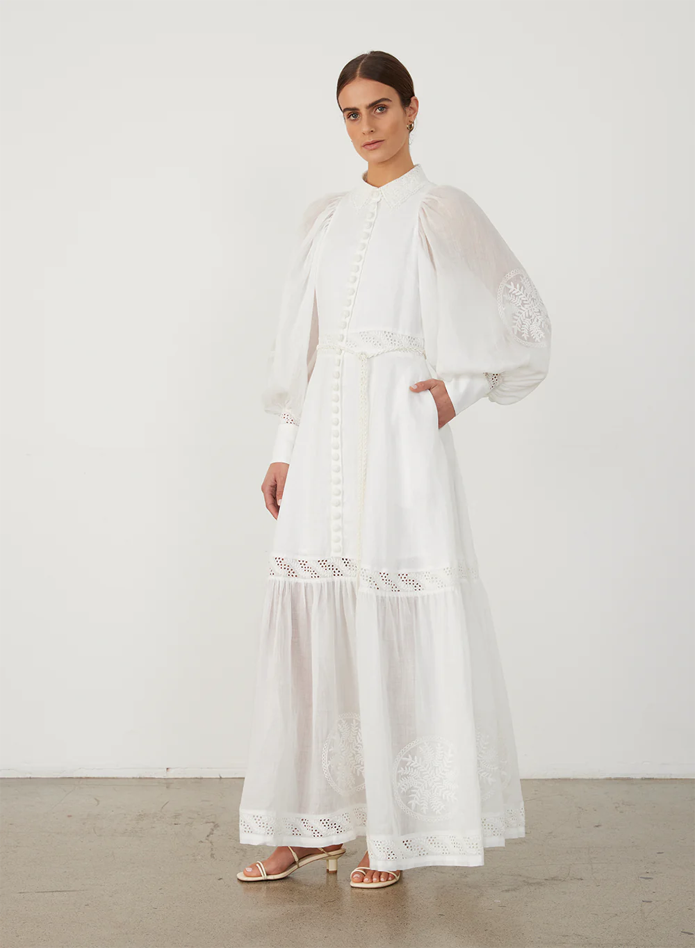 Indulge in luxury with Theodora Embroidery Dress by Joslin. The timeless shirt maxi dress boasts a classic collar and fit for a strong silhouette. The stunning ramie organdy sleeves and skirt hem panel add a touch of sophistication. Perfect for any occasion, elevate your wardrobe with this timeless piece.