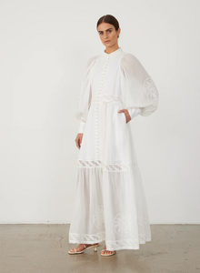 Indulge in luxury with Theodora Embroidery Dress by Joslin. The timeless shirt maxi dress boasts a classic collar and fit for a strong silhouette. The stunning ramie organdy sleeves and skirt hem panel add a touch of sophistication. Perfect for any occasion, elevate your wardrobe with this timeless piece.