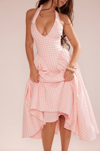 Enjoy sunny days in style with the Strawberry Midi Dress. Made from luxurious airy viscose, this dress is perfect for summer vacations. Featuring a fitted bodice and a flattering plunge halter neckline, this dress is sure to turn heads. Complete the look with a cute bow at the neck and the revealing open back.