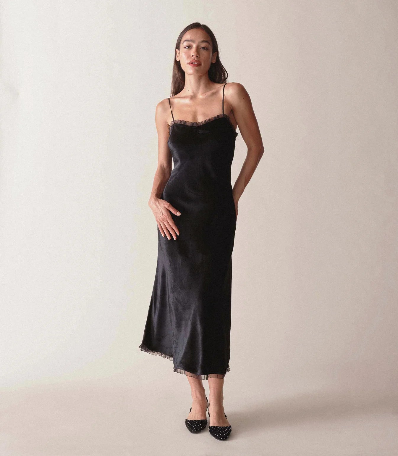 Rendered in sumptuous velvet, the Calsi Dress is a take on a ‘30s-style slip dress. It features ultra-skinny silk satin straps, bust darts for structure, and shirring at the bust for a subtle sweetheart neckline. A fitted waist gives way to an A-line skirt that falls to mid-calf, while petite silk organza ruffles adorn the neckline and hem.