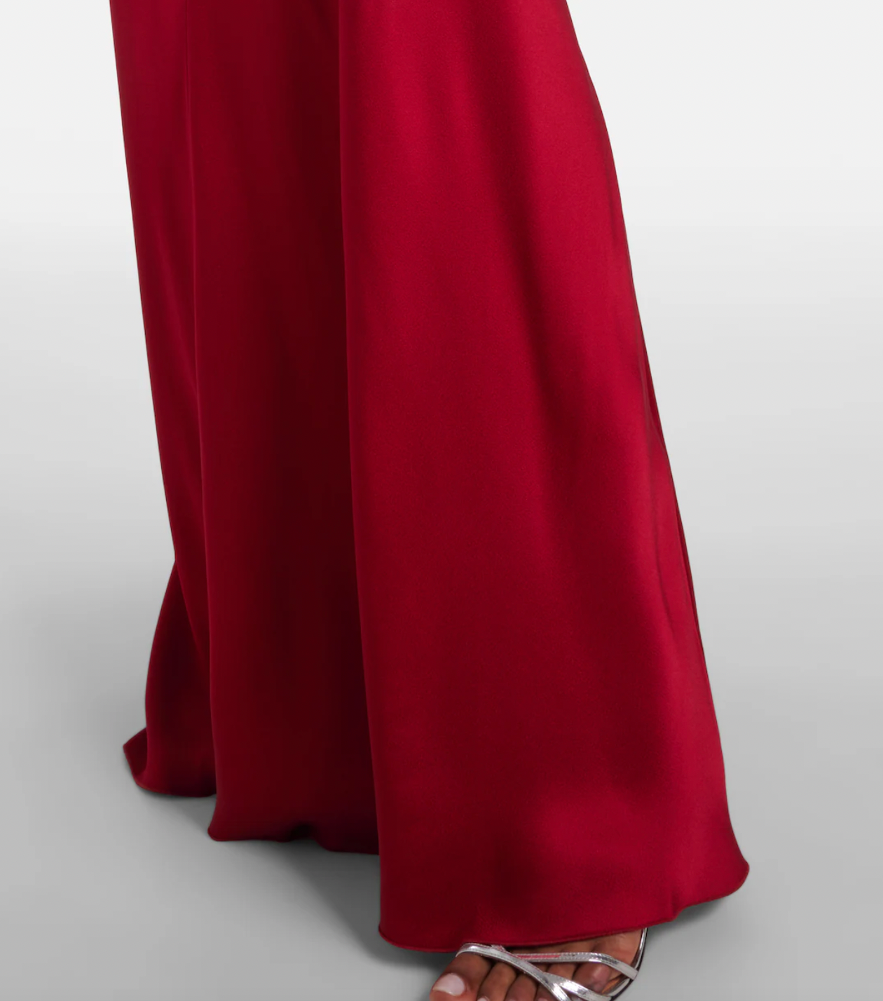 Stunning in vibrant red crêpe satin, this Victoria Beckham gown masterfully balances elegance with edge. Dramatic cape shoulders provide modest coverage while the daring open back commands attention—a sophisticated contrast that turns heads. Expertly gathered detailing sculpts a flattering hourglass silhouette, making this the perfect statement piece for unforgettable evenings. Timeless design meets modern allure.