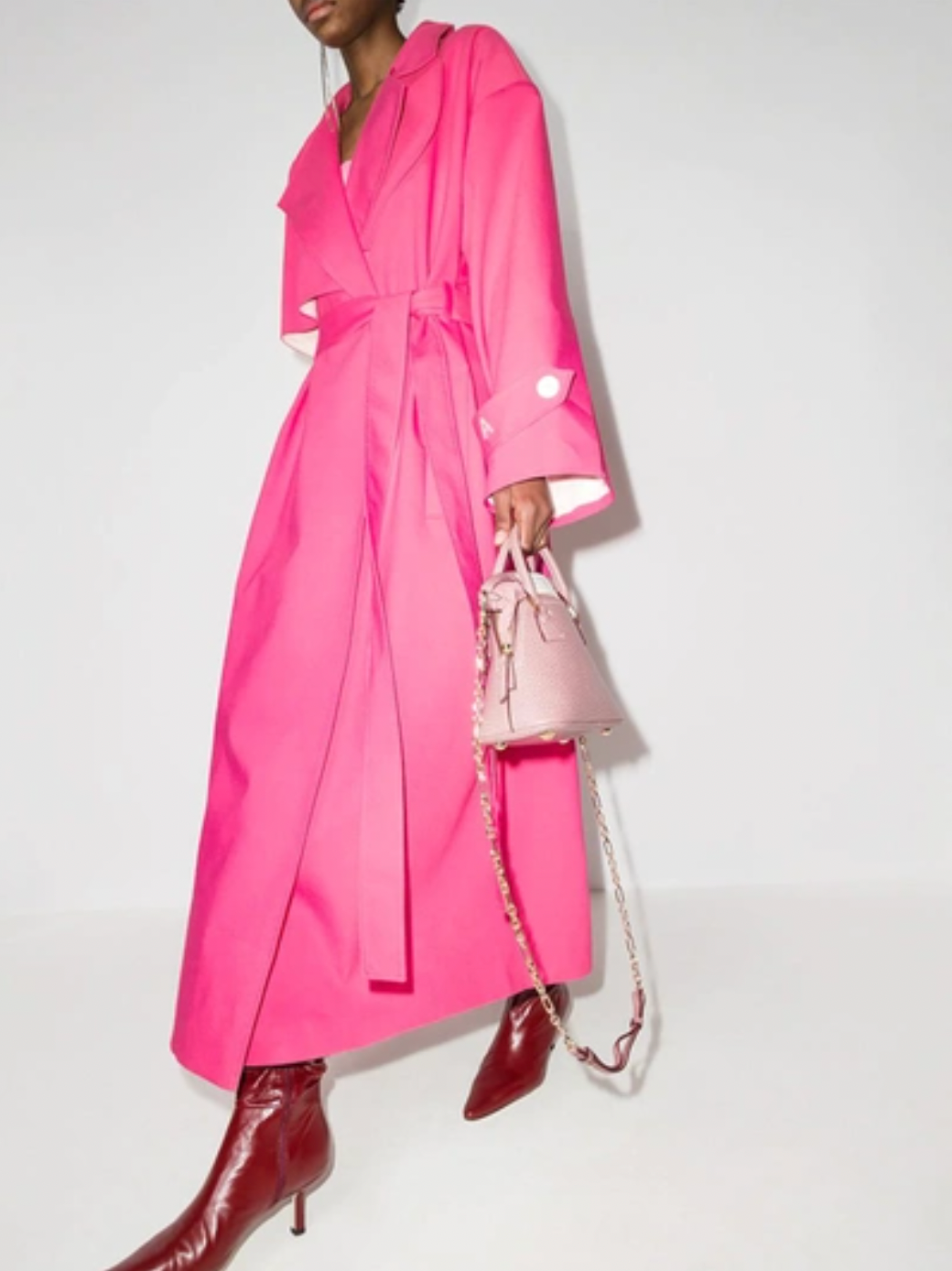 This pink ANOUKI oversized belted trench coat is designed with a wrap silhouette. Boasting a sparkling A logo to the buttoned cuff tab, it features large notched lapels, dropped shoulders, long sleeves, a back storm flap and centre vent, slip side pockets, belt loops and a self-fabric tie belt. Project Runway taught us how to 'make it work,' now flaunt what ANOUKI made you and say Auf Wiedersehen to the other coat-estants.