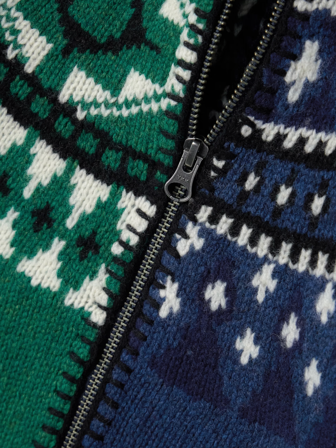 Sea's Linea cardigan masterfully blends two distinct aesthetics into one captivating piece. Crafted from sumptuous merino wool, this intarsia-knit design features Fair Isle-inspired motifs that create visual intrigue, while delicate ruffled trims add an unexpected feminine touch. The clever split construction gives the illusion of contrasting styles sewn together, making it a conversation-starting layer that transforms any basic turtleneck into an effortlessly sophisticated ensemble. 