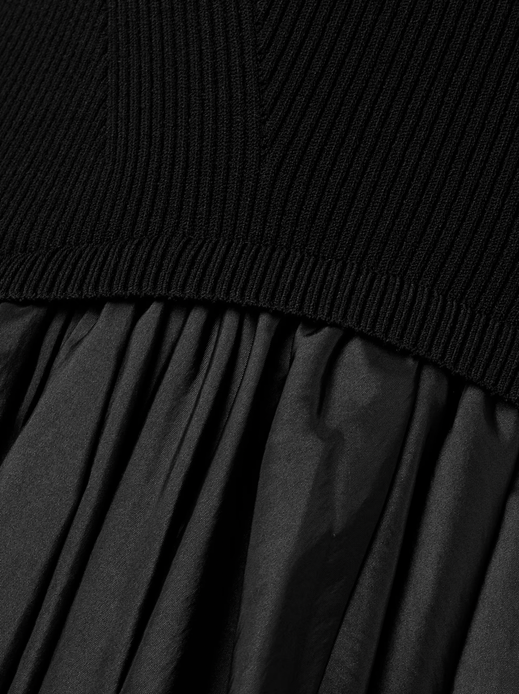 The Kenlie Ribbed-Knit and Taffeta Midi Dress by Simkhai combines a sleek, fitted bodice with a voluminous taffeta skirt that maintains its fullness thanks to soft pleats and a charming bubble hem. This elegant design offers a flattering silhouette that stays graceful whether you’re standing or sitting. Perfect for special occasions, pair it with pumps and understated jewelry to complete a sophisticated and captivating look.