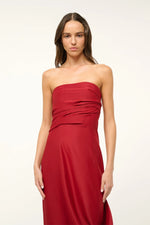 Load image into Gallery viewer, Unleash your daring side with the Caravaggio Dress Rouge by STAUD! This luxurious maxi dress, crafted from a silk wool blend, drapes elegantly and offers structural support with its built-in corset. Perfect for any adventure, this dress combines ease and sophistication. Embrace the challenge and stand out in style!
