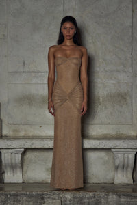 Indulge in luxury with The Starlite Dress in Diamond Sand. This strapless stretch gown boasts a chic collar, silicone gripper for a secure neckline, and an invisible zipper with hook and eye closure. The removable power mesh lining provides the perfect fit for your special event.