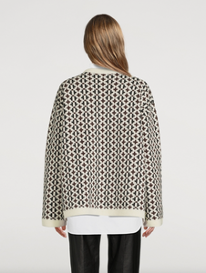 Indulge in the luxurious warmth and style of the Knit Cross-Pattern Wool Pullover by TOTEME. Crafted from high-quality virgin wool, this Norwegian-inspired piece boasts a structured fit and wide silhouette for a sophisticated look. The jacquard woven fabric features a unique cross pattern, while the ribbed neck, cuffs, and hem add texture and comfort. With dropped shoulders and side slits, this pullover is both elegant and versatile. 