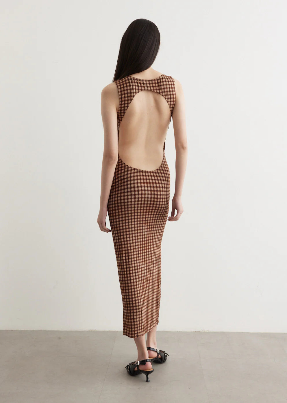 Channel your inner '90s supermodel in the Selena Dress by MIAOU. Made from a soft Tencel blend, this form-fitting maxi dress features a unique plaid pattern for a touch of sophistication. With a round neckline, sleeveless design, and open back, it's the perfect combination of French-girl style and SoCal cool.