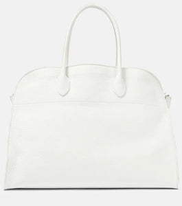 Introducing the Soft Margaux 17 Bag in White by The Row, now in luxurious grained leather. Handcrafted in Italy, this spacious tote is the perfect blend of style and comfort. Twin rolled handles, gusseted sides, and toggle closure make it both functional and fashionable. Upgrade your everyday with this must-have accessory.