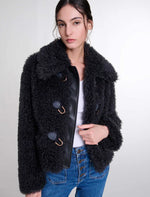 Load image into Gallery viewer, Indulge in the timeless elegance of Parisian style with the Curly Coat by Maje. This winter, our ode to sophistication and boldness features a short, textured coat adorned with golden accents. Stay warm and stylish with the wide collar, lined interior, and ribbed pockets. Perfect for a chic and casual look with a top, jeans, and booties.
