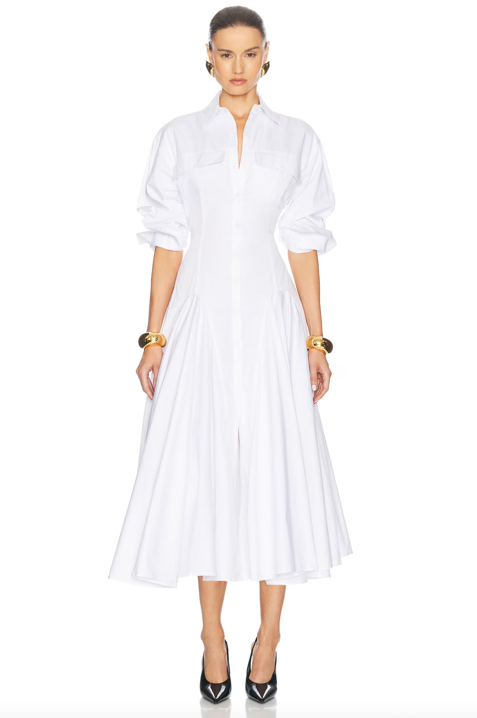 Elevate your style with the luxurious Godet Shirt Dress by Helsa. Made from premium poplin, this partially lined dress boasts a flattering fit and flare silhouette. With buttoned cuffs, front button closure, and flap pockets, it's a sophisticated and elegant must-have for your wardrobe.