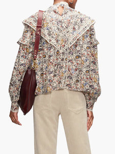Step into the free-spirited 70s with the Reign Ruffled Paisley-Print Blouse! Adopted by icons like Janis Joplin and Jimi Hendrix, this Isabel Marant Étoile blouse exudes bohemian charm with its multicoloured paisley pattern. Lightweight poplin and delicate lace-trimmed ruffles add a feminine touch. Pair with tailored trousers for a stylish contrast.