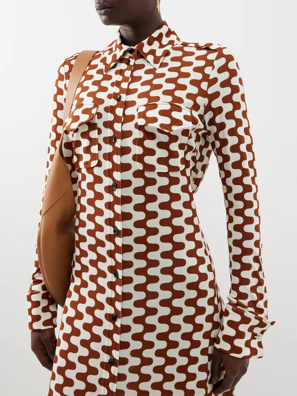 Embrace retro chic with Proenza Schouler's Printed-Jersey Maxi Shirt Dress. The brown and cream zigzag motif adds a playful touch to this sophisticated dress, made from comfortable jersey with a flattering tie-back waist and elegant fold French cuffs. Elevate your wardrobe with this exclusive piece.
