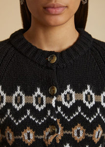 Stay cozy and stylish in the KHAITE Suzette Cardigan. This black and multicolor cardigan is made from a luxurious blend of cashmere, featuring a Fair Isle intarsia pattern and a comfortable round neck. With a button front closure, long sleeves, and ribbed details, this cardigan is the perfect addition to any outfit.