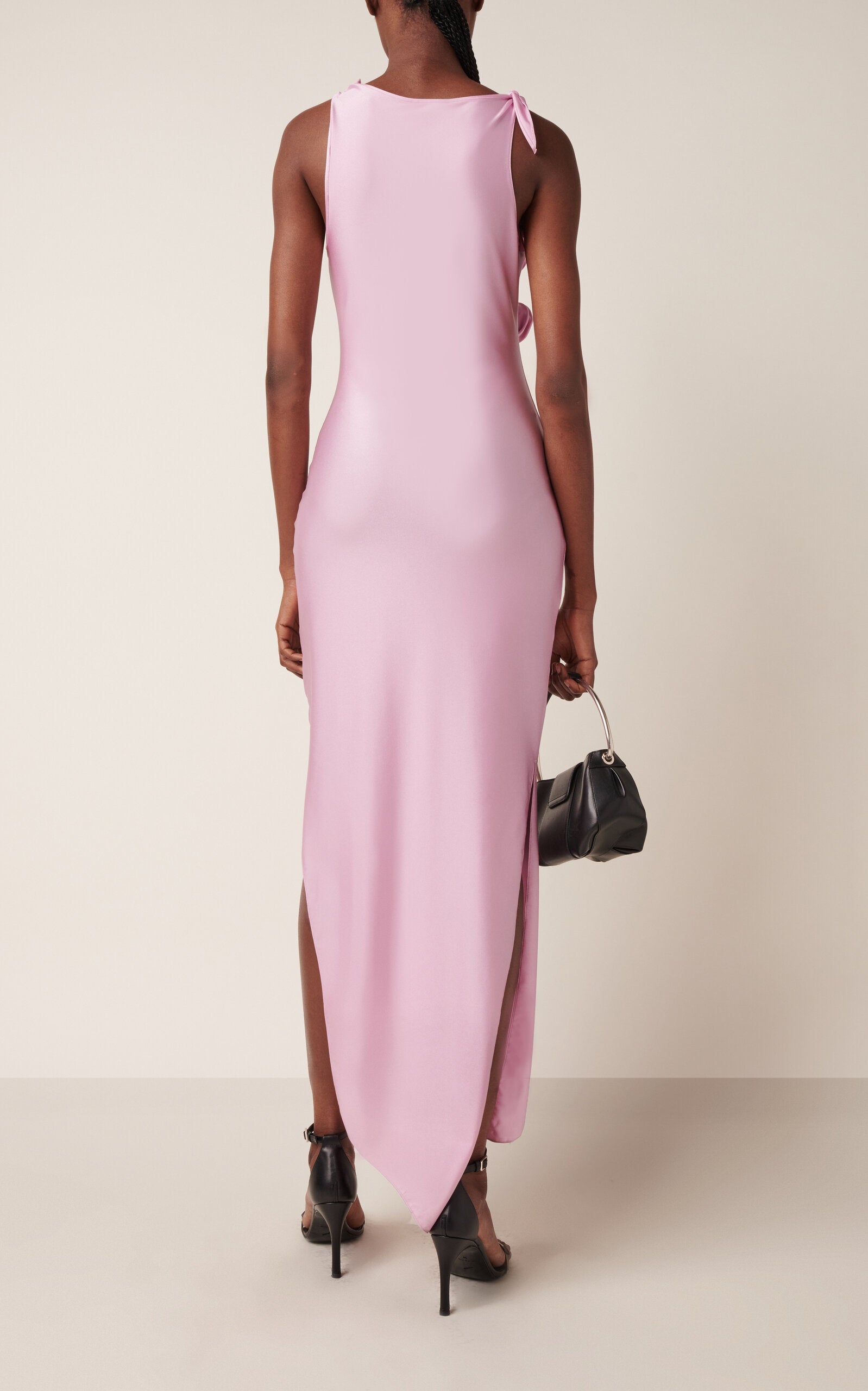 Discover the artistry of Sébastien Meyer and Arnaud Vaillant with this stunning asymmetric satin gown by Coperni. Crafted from lustrous fabric, the twisted bodice features intricate rosette-like knotting that elevates this signature silhouette into something truly extraordinary. The asymmetric cut creates an effortlessly sophisticated line, while the strategic slit hem invites you to showcase statement footwear. 